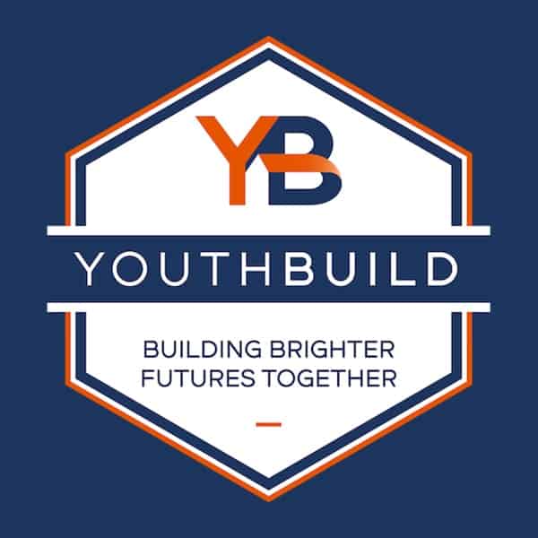 A hexagon-shaped logo with YB at the top, YOUTHBUILD in the center, and BUILDING BRIGHTER FUTURES TOGETHER below, all on a dark blue background with orange and white accents.