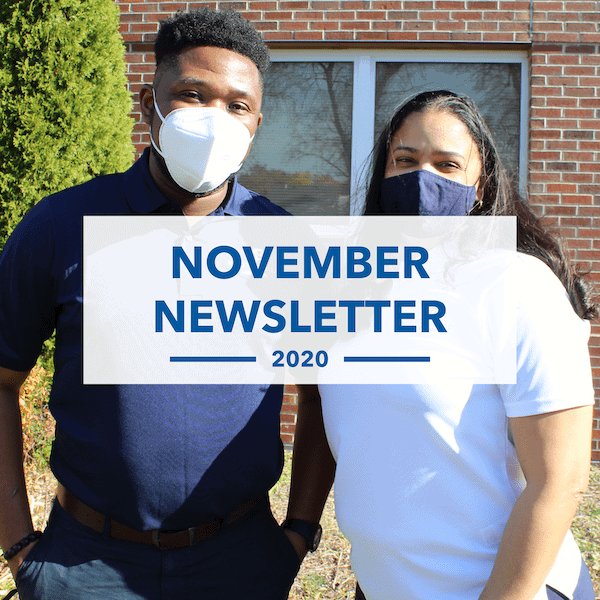 Two people wearing face masks stand outside near a brick building and greenery. A transparent overlay displays the text November Newsletter 2020 in bold blue letters.